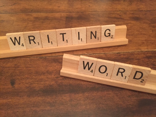 scrabble tiles that spell writing word